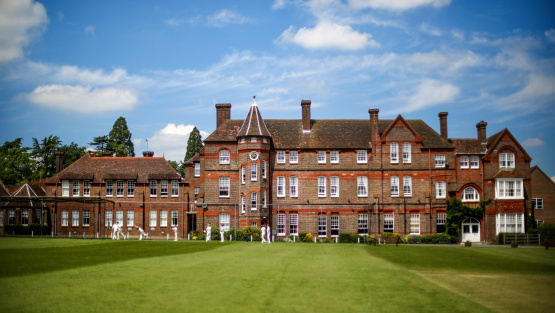 The main building of Lockers Park with cricket field in the foreground