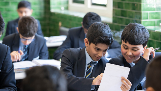 QEB pupils hard at work in classroom lined with distinctive ceramic green tiles