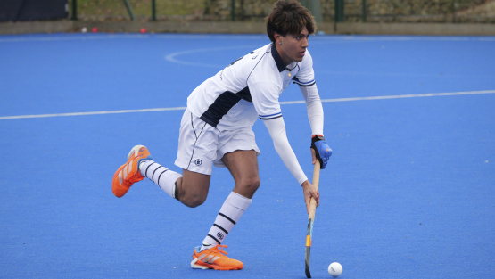Reed&rsquo;s School male hockey player on blue astroturf pitch
