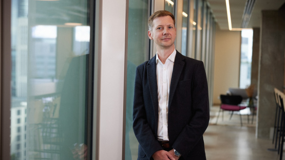 A photo portrait of Joe Askew, Selina Finance, taken in a corporate setting