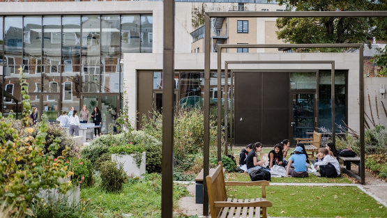 Pupils sit on the grass and others play table tennis in the garden of St Paul&rsquo;s Girls&rsquo; School, Hammersmith