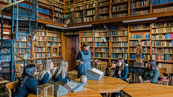 Pupils view an historic text in The Square Library at Stonyhurst College