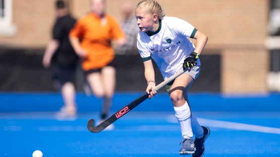 A girl playing hockey for Surbiton High School