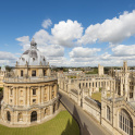 The Radcliffe Camera and All Souls College in Oxford, England. Blue, cloudy sky.